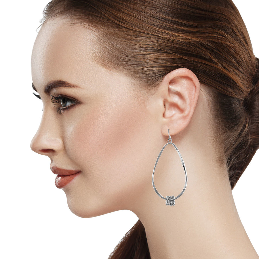 Twisted oval hoop earrings with small ring accents